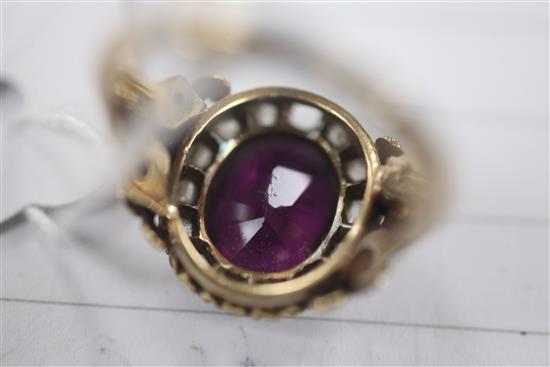A 19th century gold rhodolite? garnet and rose cut diamond oval dress ring, size Q.